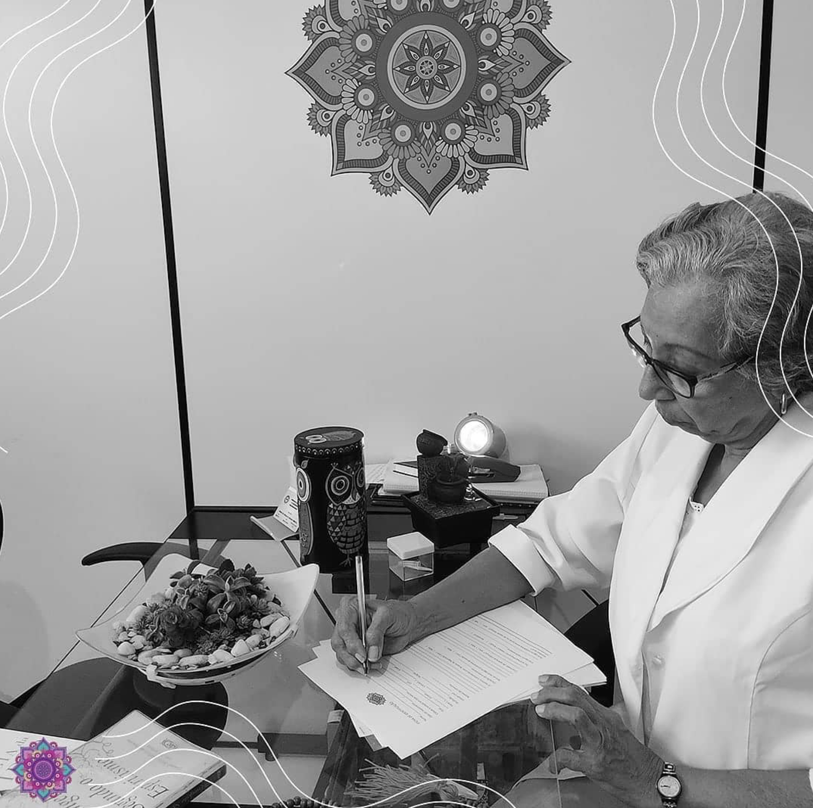 Graça Pimenta preparando documentos em sua mesa de atendimento